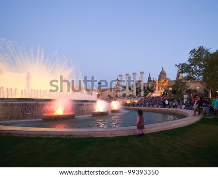 BARCELONA, SPAIN - APRIL 9: People before  National Palace of Montjuic  looking  Magic fountain in April 9, 2011 in Barcelona, Spain.  Magic fountain at Barcelona - first and famous in world