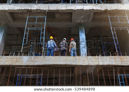 Engineer and Architect working at Construction Site