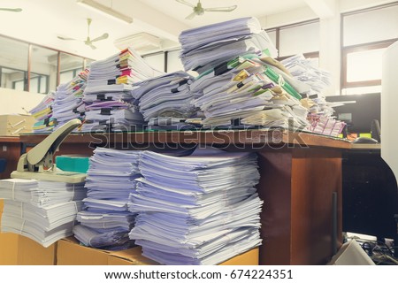 Concept of document workload, Pile of unfinished documents on office desk, Stack of business paper, Vintage effect