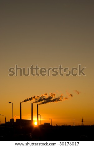 Sunset for industrial buildings with smoking pipes