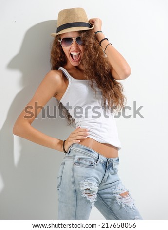Young woman with hat and sunglasses having fun - white background