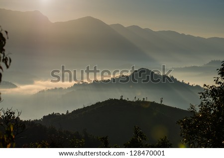View from mountains to the valley with sunrise and smog