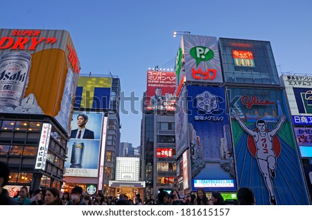 OSAKA, JAPAN - MARCH 10: The Glico Man Running billboard and other neon displays on March 10, 2014 in Dotonbori, Osaka, Japan. Dotonbori has many shops, restaurants and colorful billboards.