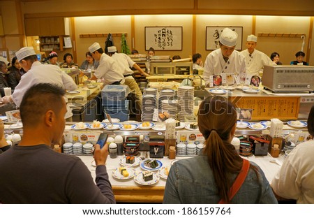 KYOTO - MARCH 5: Japanese cook prepares sushi in a restaurant on March 5, 2014 in Kyoto. Sushi is the world famous gem of Japanese cooking.