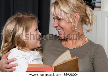 Mother reading a book to her daughter
