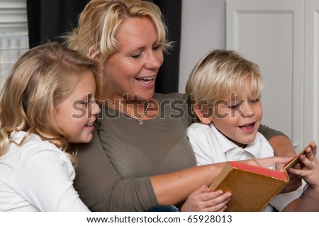 Mother reading a book to her children