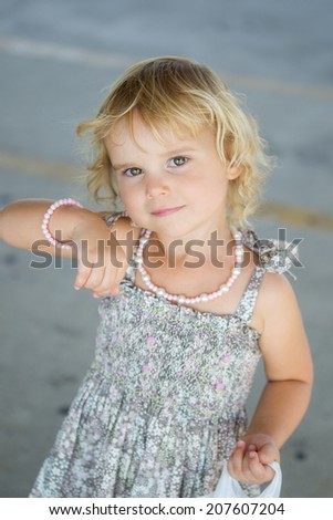 Little toddler girl showing off her jewelry