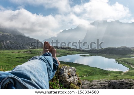 Man's Legs Relaxing in dolomite Landscape