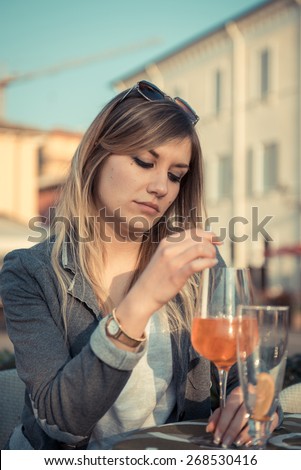 Sad depressed cute girl drinking alone