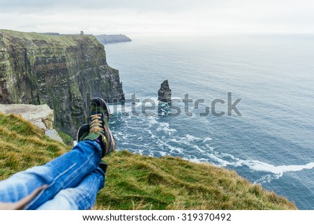 Man\'s Legs Relaxing in cliffs of moher Landscape