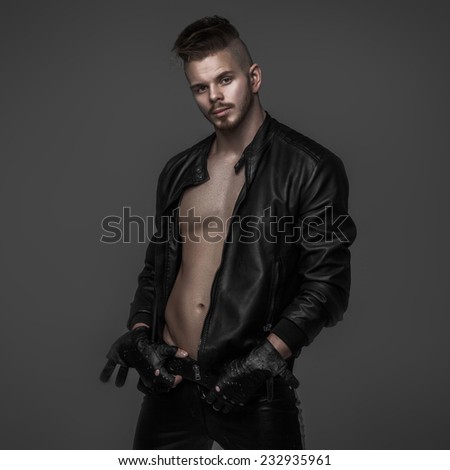 Brutal man with a mohawk in leather clothes