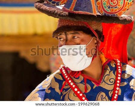 KARSHA, INDIA - JUL 17: A monk performs a religious mask dance during the Cham Dance Festival on Jul 17, 2012 in Karsha, India.