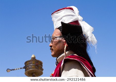 Leh,Jammu and Kashmir,India - Sep 01, 2012: A Ladakhi Man with Hand prayer wheel In Traditional Clothing on the traditional Ladakh festival on sunny cloudless day on Sep 01,Leh,Jammu and Kashmir,India
