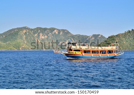 MARMARIS, TURKEY - JULY 24, 2013: Turkish houseboat with tourists at a popular Mediterranean resort on July 24, 2013 in Marmaris, Turkey.