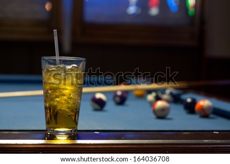 Alcoholic Drink On a Pool Table With Balls and Blue Neon Light