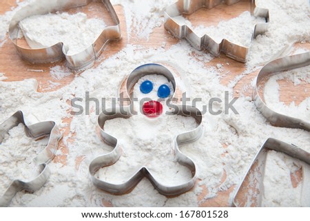 Metal Gingerbread Man Cookie Cutter in Freshly Sifted Flour With Jelly Bean Face