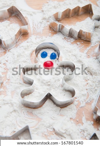 Metal Gingerbread Man Cookie Cutter in Freshly Sifted Flour With Jelly Bean Face