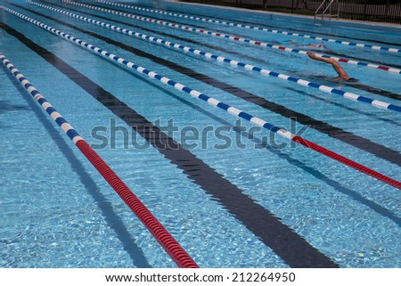 Man Swimming Laps in Outdoor Swimming Pool With Lap Lanes