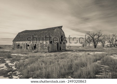 Sanborn Barn, black and white dilapidated barn on the eastern plains
