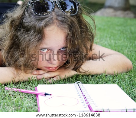 Beautiful  girl drew heart on the notepad and She crying over them