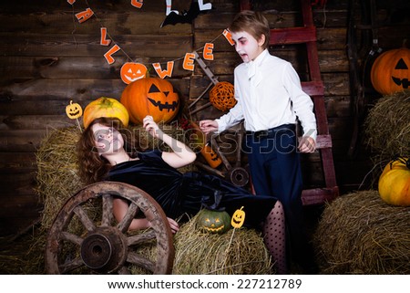 Boy and girl wearing halloween costume. Vampire and victim.