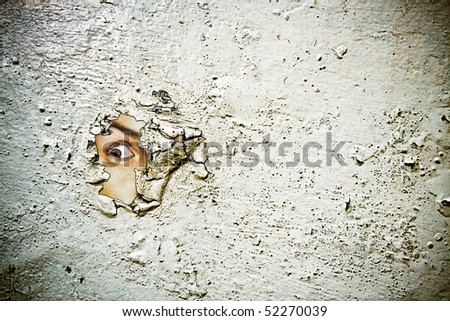 eye curiously peaking through the old painted ruined surface