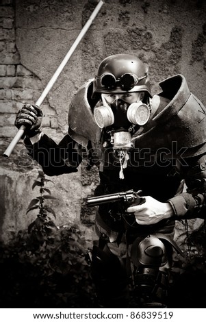 armored postnuclear fighter with a gun and metal club