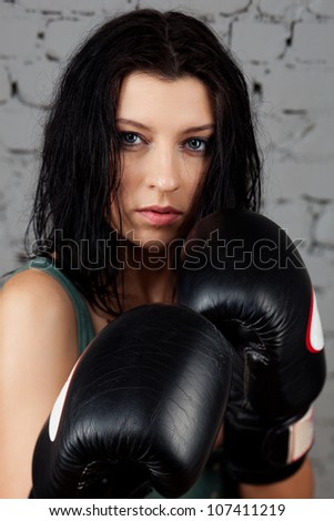Portrait of sexy boxer girl with gloves on hands
