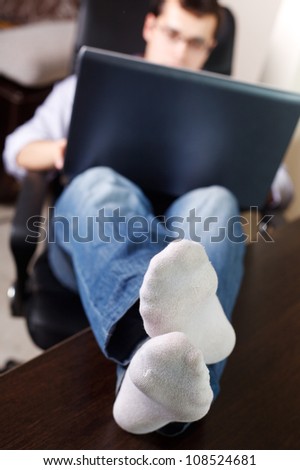 Self-employed man working at home. Resting - feet on the table