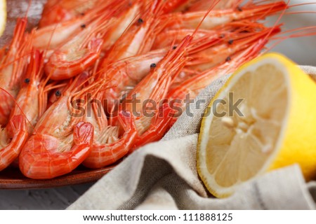 Healthy grilled prawns served with a halved lemon and napkin to clean ones fingers during eating