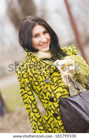 Outdoor portrait of young pretty beautiful woman in cold spring weather in park. Sensual brunette posing and having fun