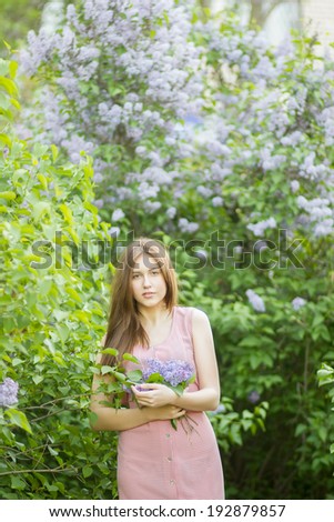 Portrait of a beautiful young woman with long brown hair that morning walks through landmark.