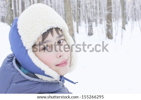 Boy play in the winter forest, portrait
