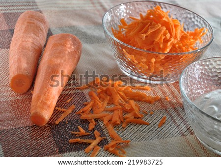 Grated carrots, sour cream and oil in the kitchen