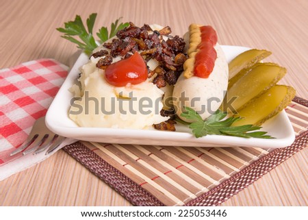 Bavarian or Munich sausage with mashed potatoes, cracklings and pickle