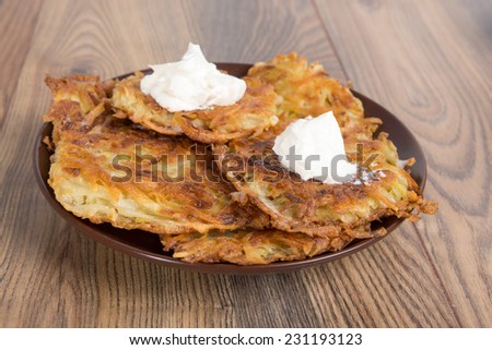 potato pancakes - draniki - with sour cream - the national dish of Ukrainian and Belarusian cuisine