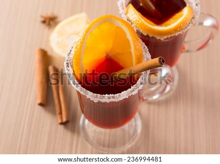 mulled wine in clear glass mug on a wooden table