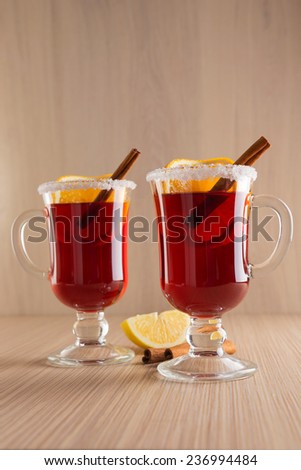 mulled wine in clear glass mug on a wooden table