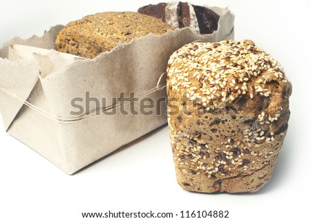 bread with caraway seeds on the background of different types of bread in the package