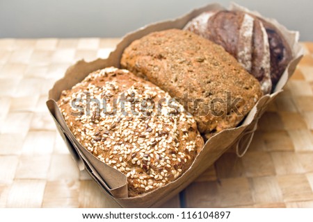 three types of bread, bread with caraway seeds, rye bread, bread with spices in a package with a bow