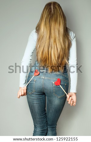 blonde with long hair from behind with hearts in their hands