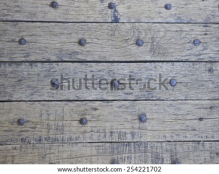 Old studded wood boards with rows of rivets