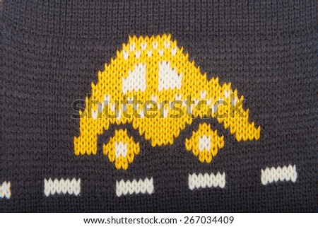 Colorful knitted wool background. Figure knitted cars