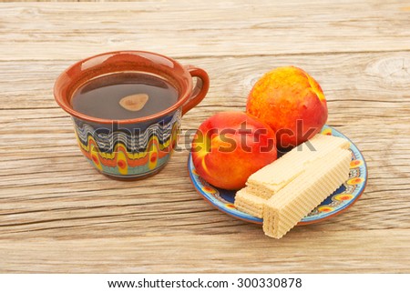 Ethnic cup of coffee and Wafer biscuit on the beautiful old wooden background
