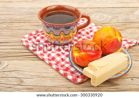 Ethnic cup of coffee and Wafer biscuit on the beautiful old wooden background