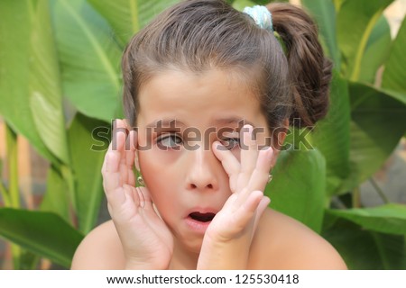 beautiful child touches around,best focus on the face, blurred background
