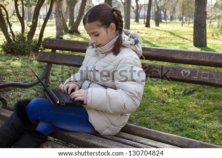 beautiful girl with lap top,best focus on the hands and lap top, soft focus on the face, blurred background