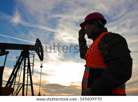 worker in the oil field industry at dusk,image soft focus,  best focus on the worker
