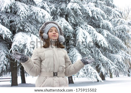 girl standing with open arms in the snow and keep your eyes closed,best focus cap, belt and jacket, soft focus face