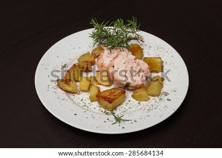 restaurant dish of roast meat with potatoes and rosemary